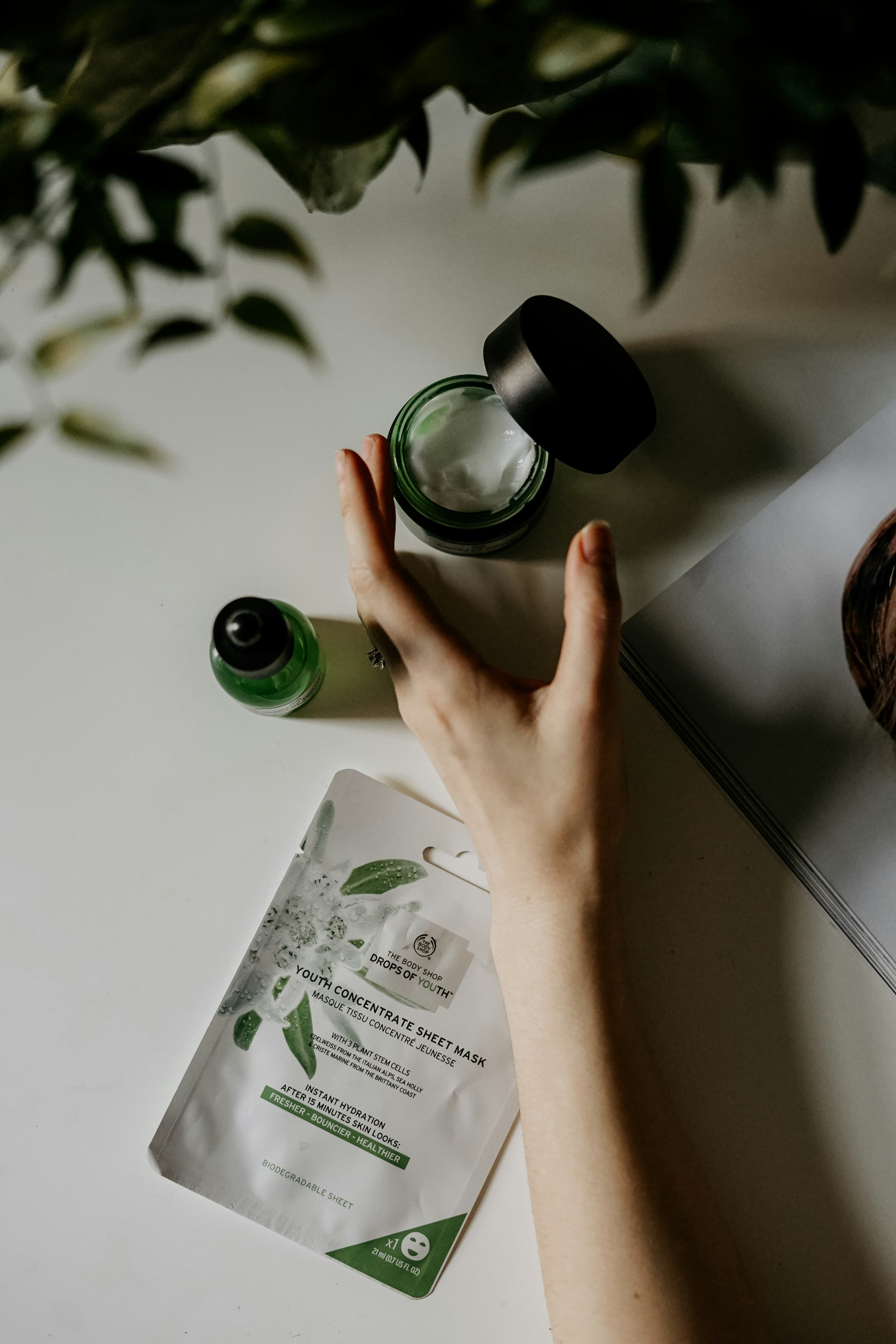 Raw botanical skincare ingredients layout with organic essence droplets